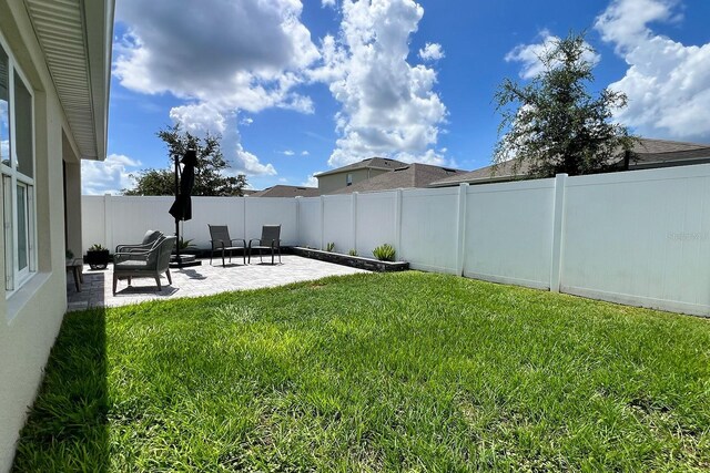 2727 Harmonia Hammock Rd, Harmony, FL 34773 - fenced backyard featuring a patio area