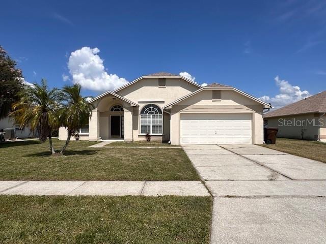 123 Moss Bluff Rd, Kissimmee, FL 34746 - ranch-style house with an attached garage, a front lawn, stucco siding, and concrete driveway