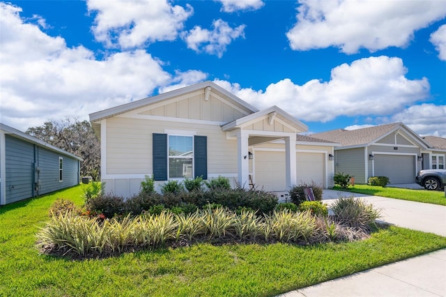 1959 Cricket Cradle Dr, Kissimmee, FL 34746 - view of front of property with an attached garage, concrete driveway, board and batten siding, and a front lawn