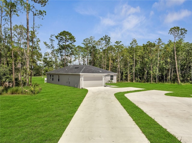33 Peterlee Ct, Kissimmee, FL 34758 - view of home's exterior featuring a yard, driveway, stucco siding, and a view of trees