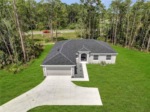33 Peterlee Ct, Kissimmee, FL 34758 - ranch-style home featuring a front yard, concrete driveway, a garage, stucco siding, and roof with shingles