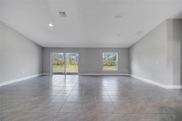 33 Peterlee Ct, Kissimmee, FL 34758 - tiled empty room featuring lofted ceiling and recessed lighting