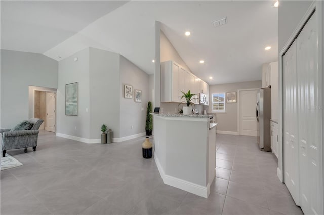 33 Peterlee Ct, Kissimmee, FL 34758 - corridor with high vaulted ceiling, light tile patterned flooring, and recessed lighting