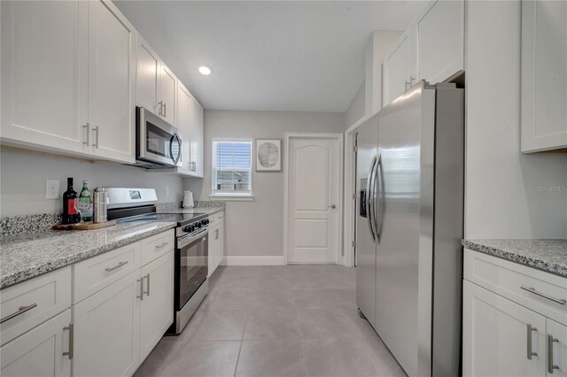33 Peterlee Ct, Kissimmee, FL 34758 - kitchen with appliances with stainless steel finishes, white cabinets, and light tile patterned floors