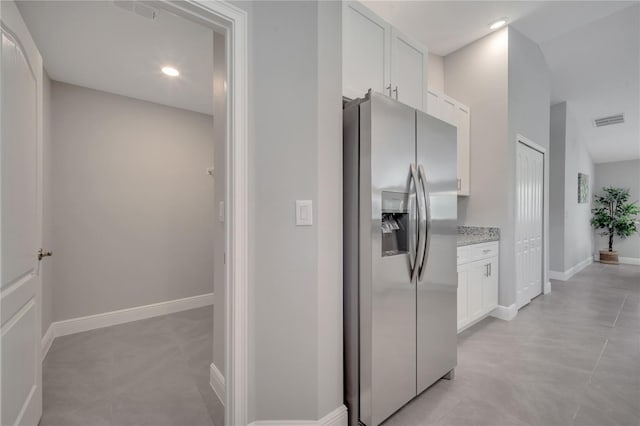 33 Peterlee Ct, Kissimmee, FL 34758 - kitchen with stainless steel fridge, white cabinetry, light stone counters, and recessed lighting