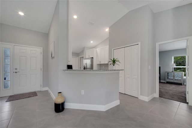 33 Peterlee Ct, Kissimmee, FL 34758 - entryway with light tile patterned floors, high vaulted ceiling, and recessed lighting