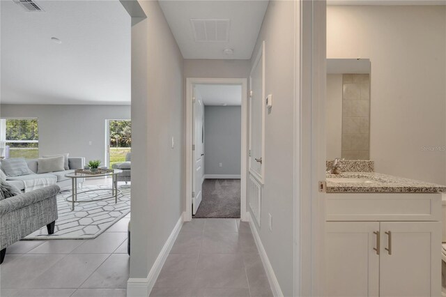 33 Peterlee Ct, Kissimmee, FL 34758 - corridor with a sink and light tile patterned floors