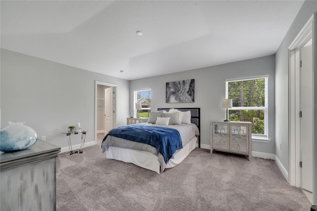 33 Peterlee Ct, Kissimmee, FL 34758 - carpeted bedroom featuring baseboards and connected bathroom