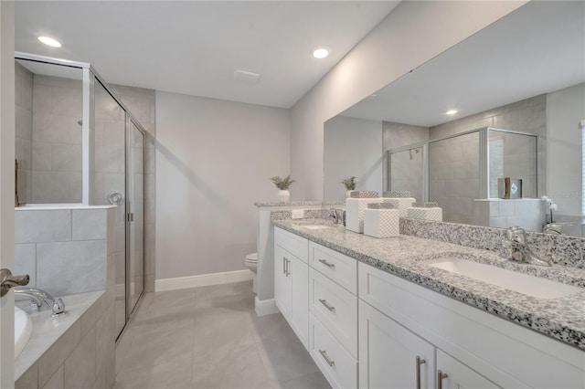 33 Peterlee Ct, Kissimmee, FL 34758 - full bath with double vanity, a shower stall, a garden tub, recessed lighting, and tile patterned flooring