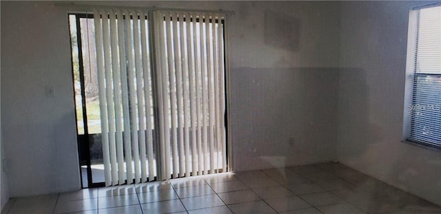 2002 Cascades Blvd Unit 108, Kissimmee, FL 34741 - empty room with tile patterned flooring and plenty of natural light