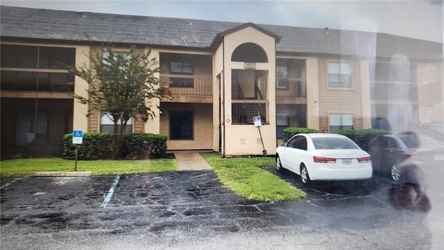2002 Cascades Blvd Unit 108, Kissimmee, FL 34741 - view of property with uncovered parking