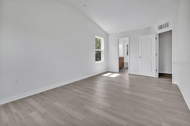 303 Anchovie Ct, Poinciana, FL 34759 - unfurnished bedroom with lofted ceiling and wood finished floors