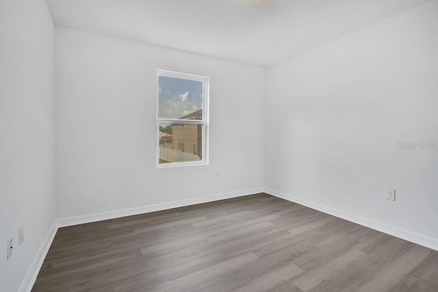303 Anchovie Ct, Poinciana, FL 34759 - empty room featuring wood finished floors