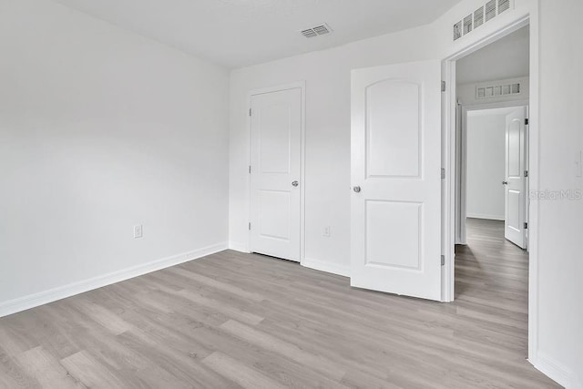 303 Anchovie Ct, Poinciana, FL 34759 - unfurnished bedroom with light wood-style floors and baseboards