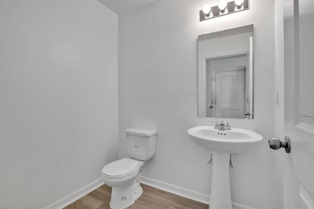 303 Anchovie Ct, Poinciana, FL 34759 - bathroom featuring wood finished floors and toilet