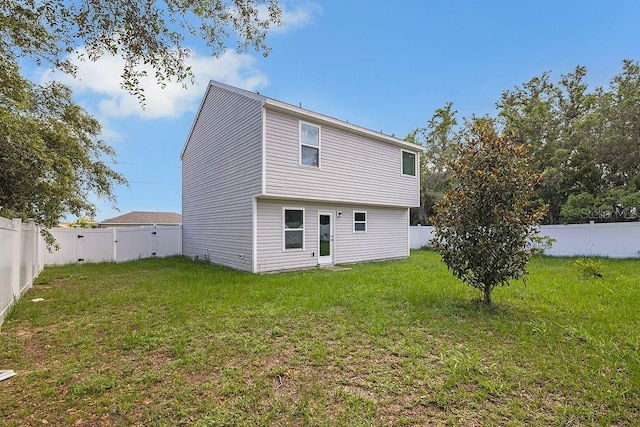 303 Anchovie Ct, Poinciana, FL 34759 - rear view of property with a fenced backyard