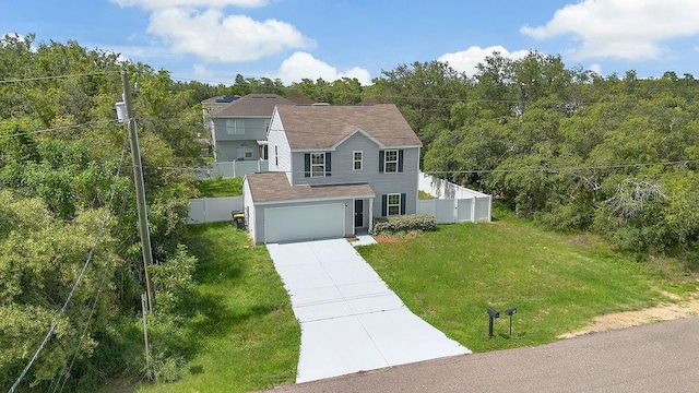 303 Anchovie Ct, Poinciana, FL 34759 - view of front of home featuring concrete driveway, a garage, and a wooded view