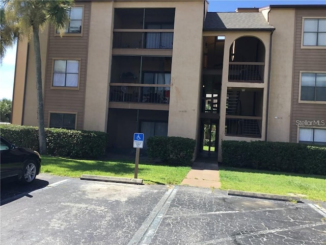 2202 Cascades Blvd Unit 201, Kissimmee, FL 34741 - view of property with uncovered parking