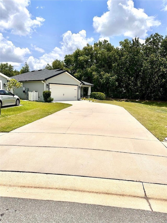 144 Foxtail Loop, Davenport, FL 33837 - view of property exterior with a lawn, concrete driveway, and an attached garage
