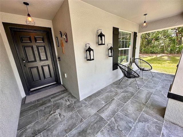 144 Foxtail Loop, Davenport, FL 33837 - property entrance with stucco siding and a porch