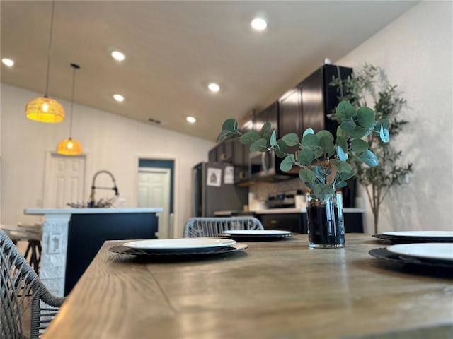 144 Foxtail Loop, Davenport, FL 33837 - dining room with recessed lighting, finished concrete flooring, and lofted ceiling