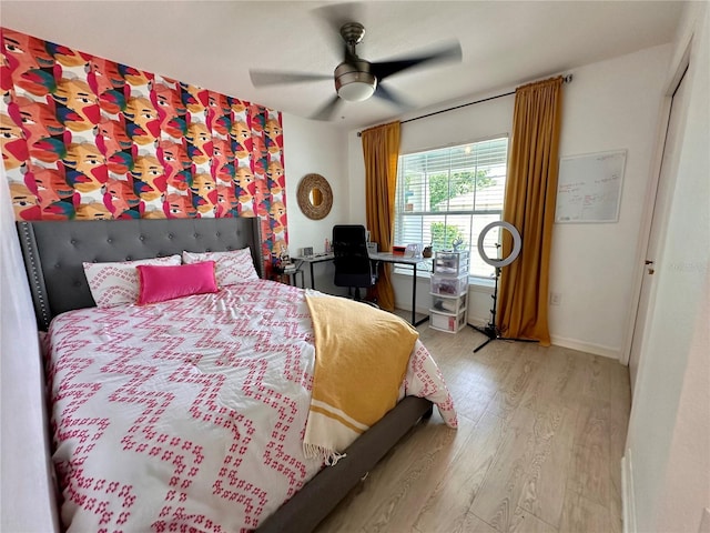 144 Foxtail Loop, Davenport, FL 33837 - bedroom with light wood finished floors and ceiling fan