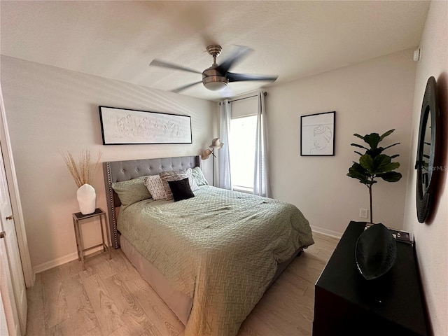 144 Foxtail Loop, Davenport, FL 33837 - bedroom featuring light wood-style floors and a ceiling fan