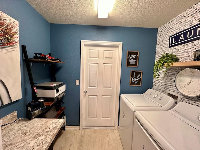 144 Foxtail Loop, Davenport, FL 33837 - washroom with a textured ceiling, washer and dryer, and light wood finished floors