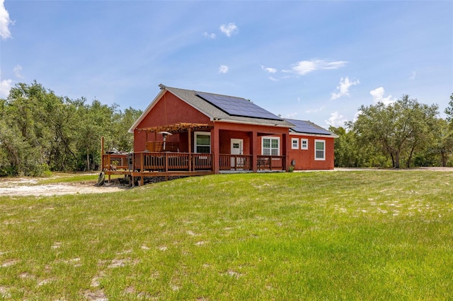 2576 R E Byrd Rd, Frostproof, FL 33843 - view of front of property with roof mounted solar panels, a front yard, and a deck