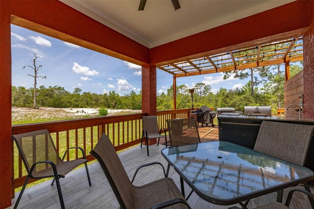 2576 R E Byrd Rd, Frostproof, FL 33843 - wooden terrace with outdoor dining area, ceiling fan, and a pergola