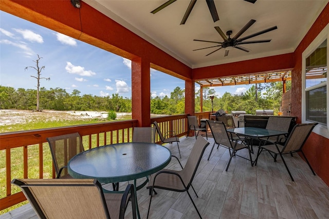 2576 R E Byrd Rd, Frostproof, FL 33843 - view of patio featuring outdoor dining area, ceiling fan, a wooden deck, and view of scattered trees