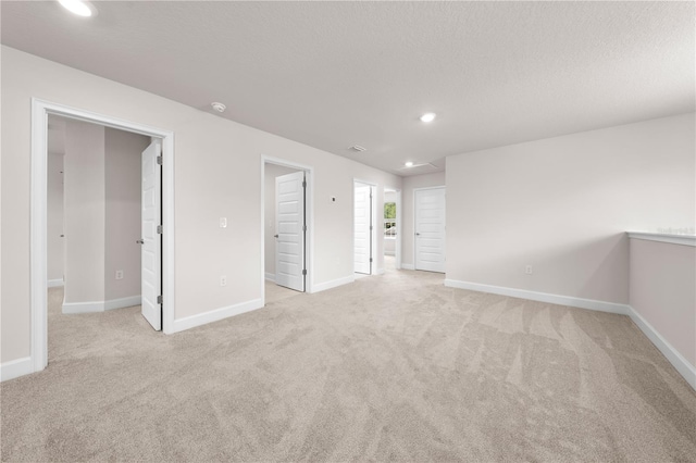 7413 Bent Tree Loop, Saint Cloud, FL 34771 - spare room with light colored carpet, recessed lighting, and a textured ceiling