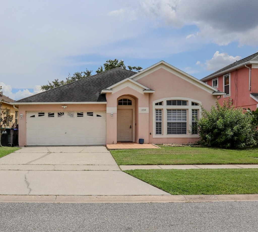 1730 Sir John Ct, Orlando, FL 32837 - single story home with stucco siding, driveway, a garage, a front lawn, and roof with shingles