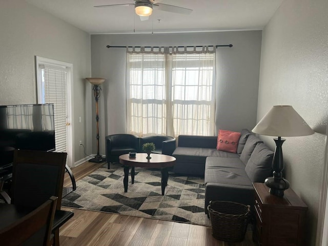 4862 Cayview Ave Unit 40409, Orlando, FL 32819 - living room featuring a ceiling fan, wood finished floors, and a textured wall