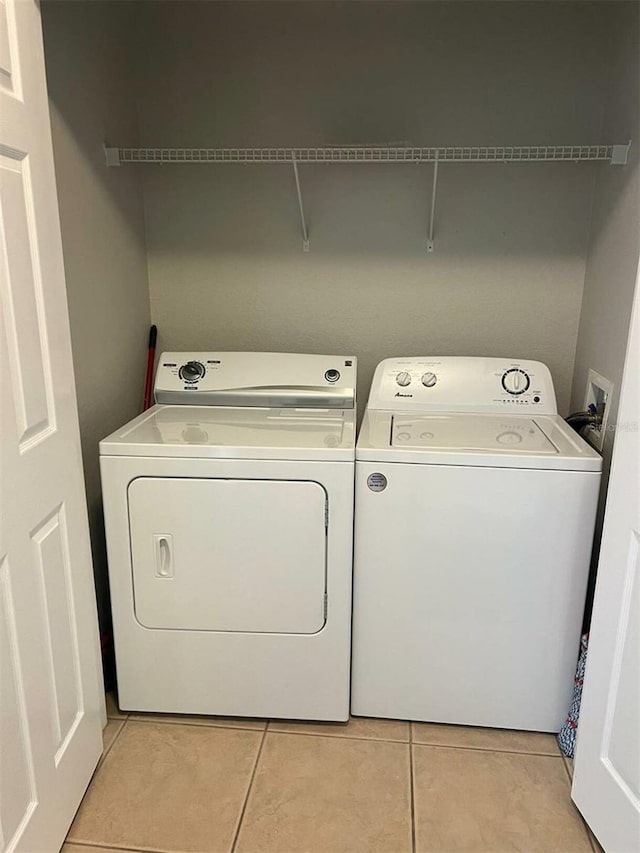 4862 Cayview Ave Unit 40409, Orlando, FL 32819 - laundry area with independent washer and dryer and light tile patterned flooring