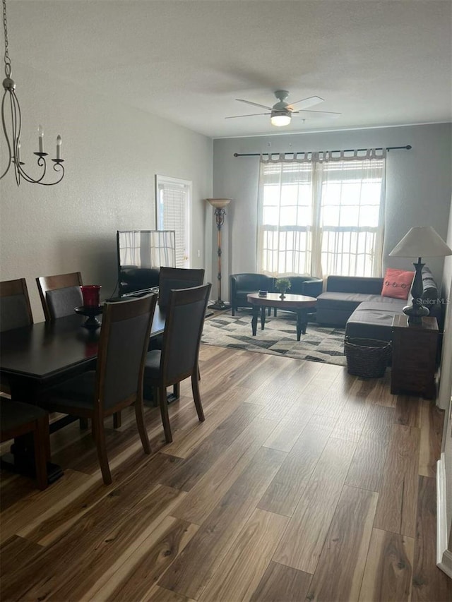 4862 Cayview Ave Unit 40409, Orlando, FL 32819 - dining room with wood finished floors, a ceiling fan, and a chandelier
