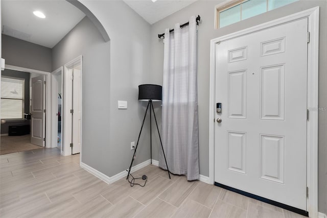 11051 Bostwick Aly, Winter Garden, FL 34787 - foyer with arched walkways and light wood-style floors