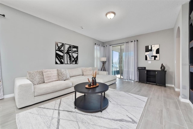 11051 Bostwick Aly, Winter Garden, FL 34787 - living room with arched walkways and baseboards