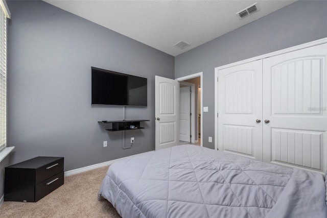 11051 Bostwick Aly, Winter Garden, FL 34787 - bedroom featuring carpet flooring, a closet, and a textured ceiling