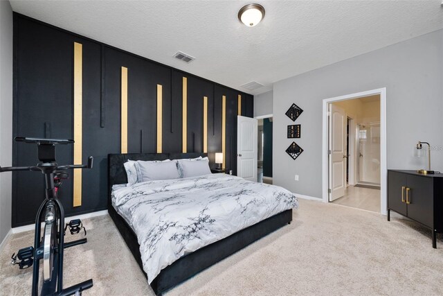 11051 Bostwick Aly, Winter Garden, FL 34787 - bedroom with light carpet, a textured ceiling, and ensuite bathroom