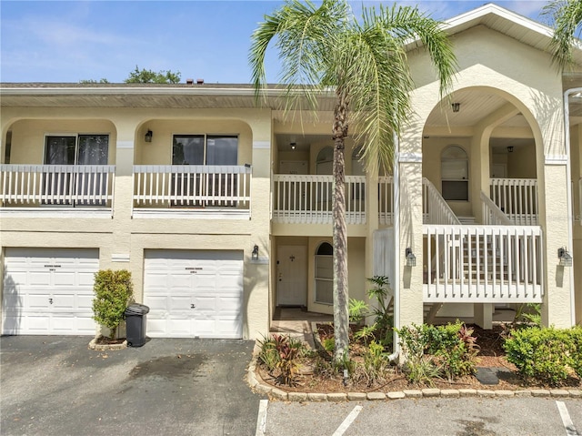 3205 Sabal Palms Ct Unit A, Kissimmee, FL 34747 - townhome / multi-family property featuring stucco siding, an attached garage, and driveway