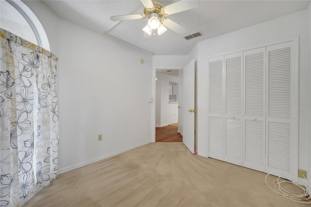 3205 Sabal Palms Ct Unit A, Kissimmee, FL 34747 - unfurnished bedroom with light carpet, a closet, and a ceiling fan