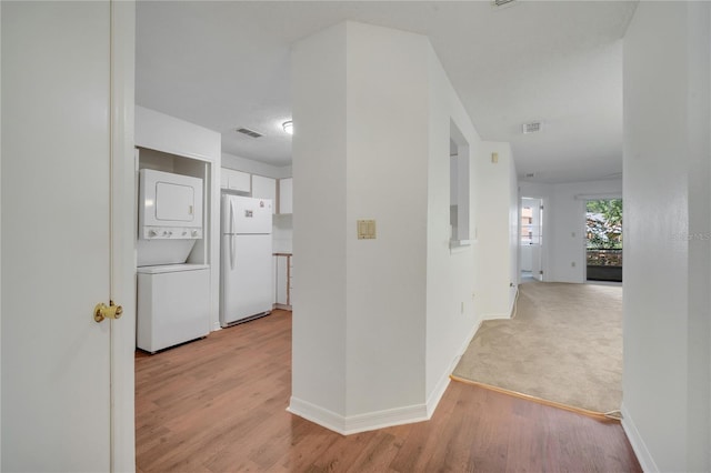 3205 Sabal Palms Ct Unit A, Kissimmee, FL 34747 - corridor featuring stacked washer / drying machine and light wood-style flooring