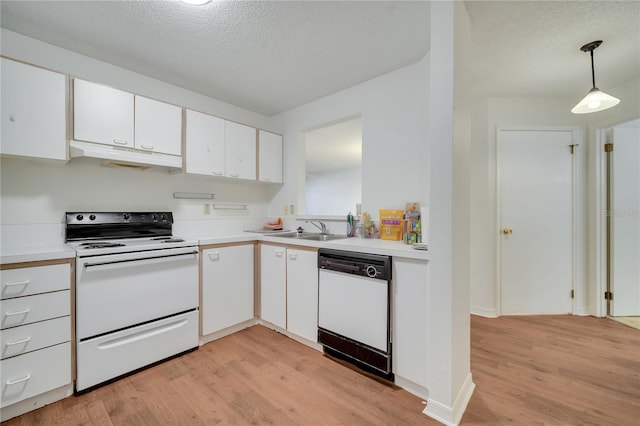 3205 Sabal Palms Ct Unit A, Kissimmee, FL 34747 - kitchen with white appliances, under cabinet range hood, light wood-type flooring, white cabinetry, and a textured ceiling
