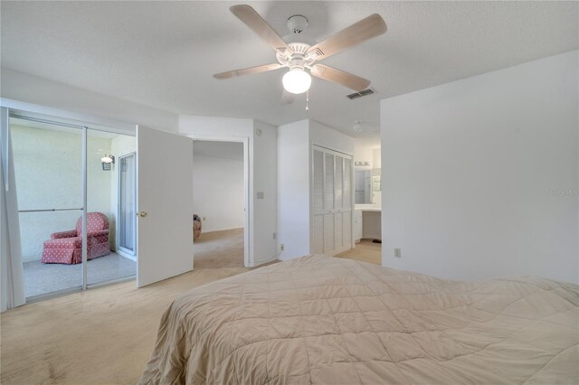 3205 Sabal Palms Ct Unit A, Kissimmee, FL 34747 - bedroom with light colored carpet, two closets, and a ceiling fan