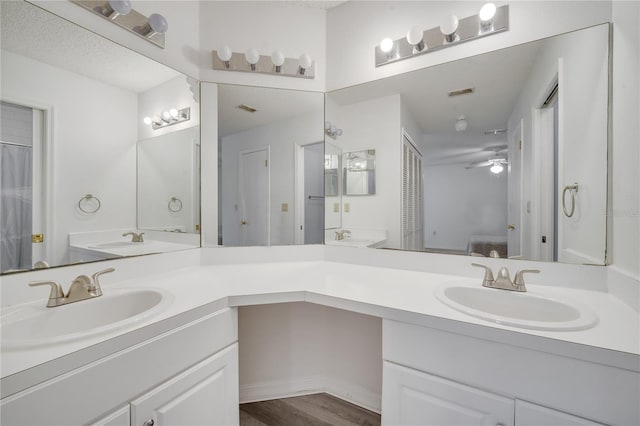 3205 Sabal Palms Ct Unit A, Kissimmee, FL 34747 - full bathroom with double vanity, ceiling fan, ensuite bath, and wood finished floors