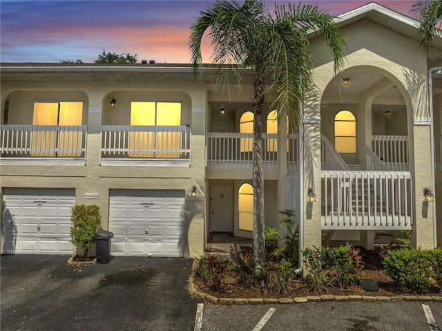 3205 Sabal Palms Ct Unit A, Kissimmee, FL 34747 - view of front facade featuring stucco siding, a balcony, a garage, and driveway