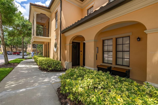 502 Mirasol Cir Unit 103, Kissimmee, FL 34747 - view of exterior entry featuring stucco siding and a tile roof