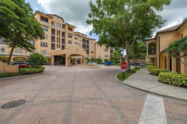 502 Mirasol Cir Unit 103, Kissimmee, FL 34747 - view of decorative road featuring curbs, traffic signs, and sidewalks