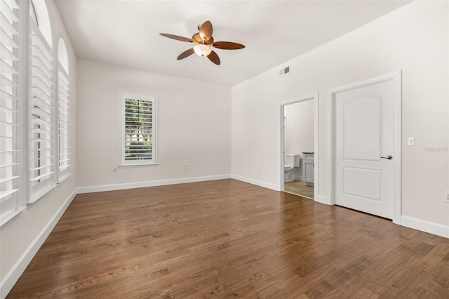 502 Mirasol Cir Unit 103, Kissimmee, FL 34747 - unfurnished bedroom featuring wood finished floors, connected bathroom, and a ceiling fan